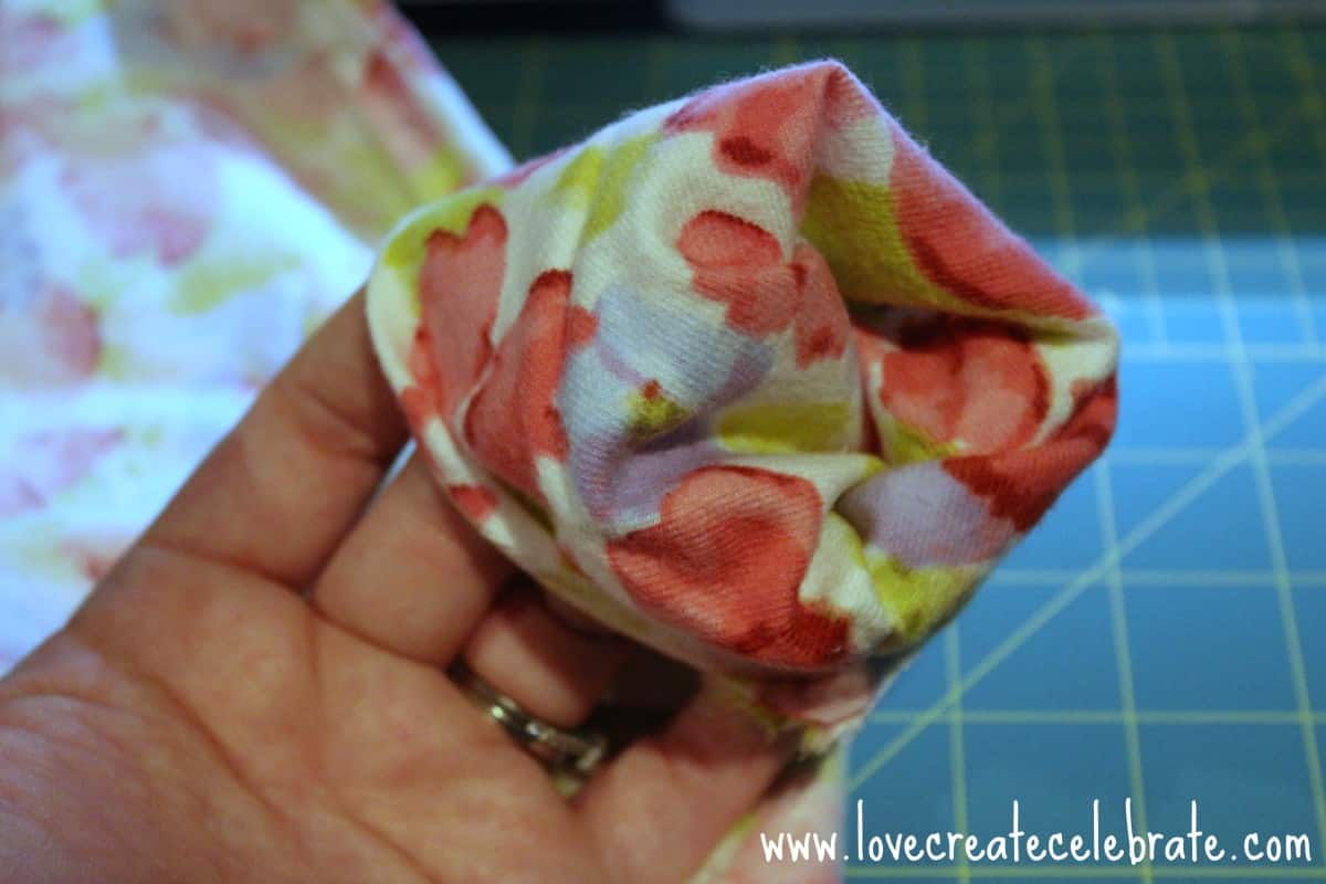 Flowered fabric for infinity scarf on a woman's finger tips
