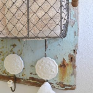 Pretty shabbiness! This blogger took an old piece of wood washed up on the beach and made this adorable rustic towel holder with it!