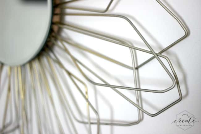 Old wire hangers create the sunburst effect on this DIY sunburst mirror