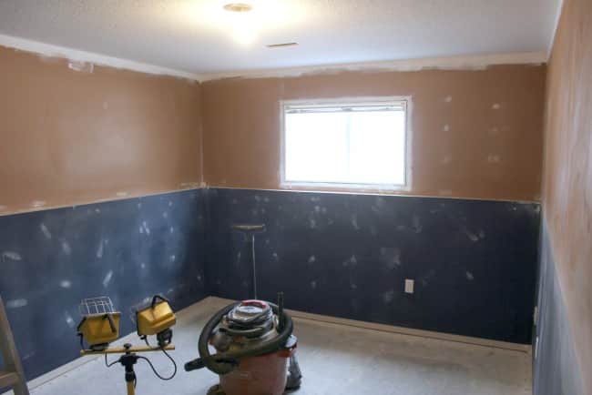Walls patched and carpet removed from guest bedroom to install vinyl plank flooring