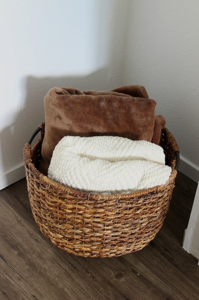Extra blankets in a basket in the cozy guest suite.