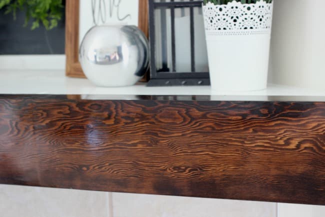 The gloss finish on this wooden mantel shows off the beautiful wood grain