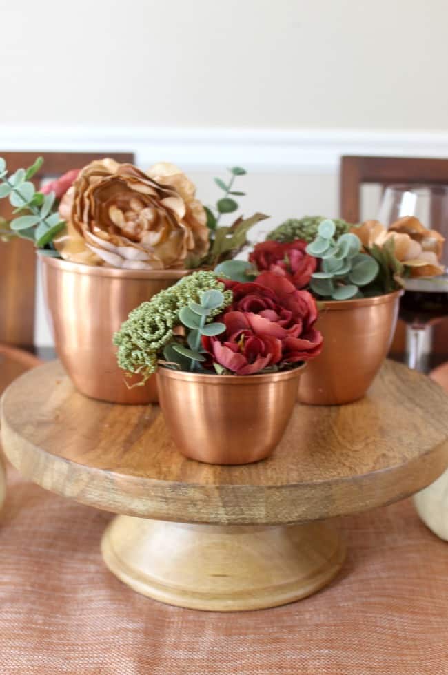 Beautiful inspiration for a fall tablescape! Beautiful ideas for a Thanksgiving Day table too! Love the combination of woods, coppers, and florals.