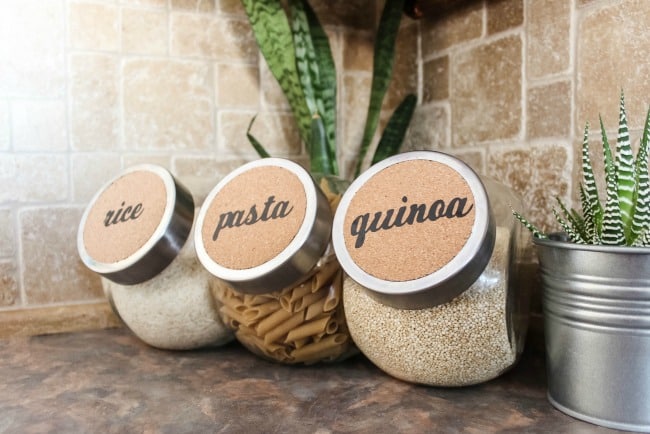 Quick and easy cork labels to organize your kitchen or bathroom! Turn dollar store buys into stylish decor with the Cricut Machine!