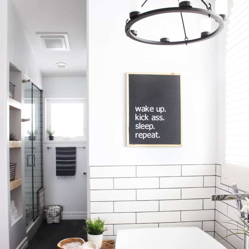 Make your own custom typography canvas with iron-on vinyl and paint. A sleek modern canvas for your bedroom or bathroom. Love the "wake up. kick ass. sleep. repeat." Art in a beautiful modern bathroom.