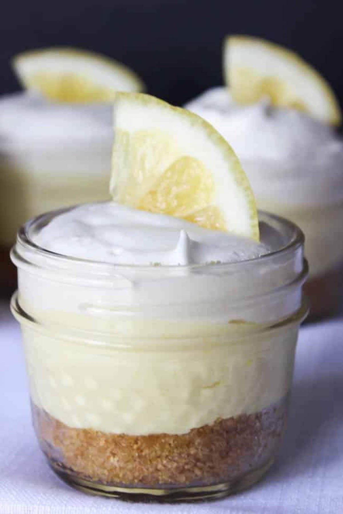 close up of lemon cheesecake dessert in mini mason jars