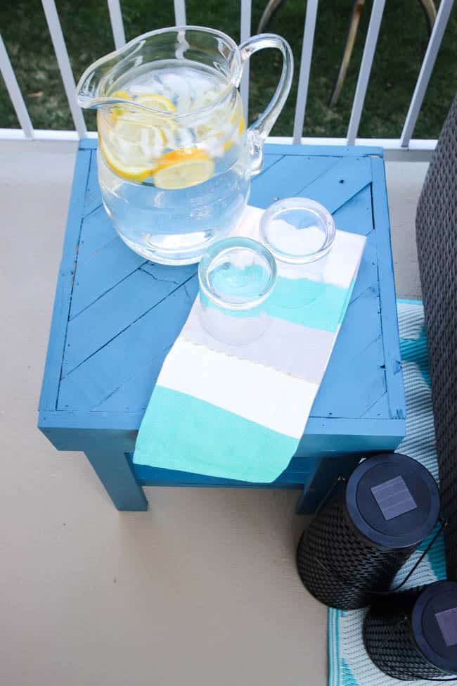 A stunning backyard makeover inspired completed with Behr paints. Love the bright painted blue doors, and the grey outdoor sectional. Beautiful DIY pallet side tables, and black and white accessories complete the space. Summer is here! 