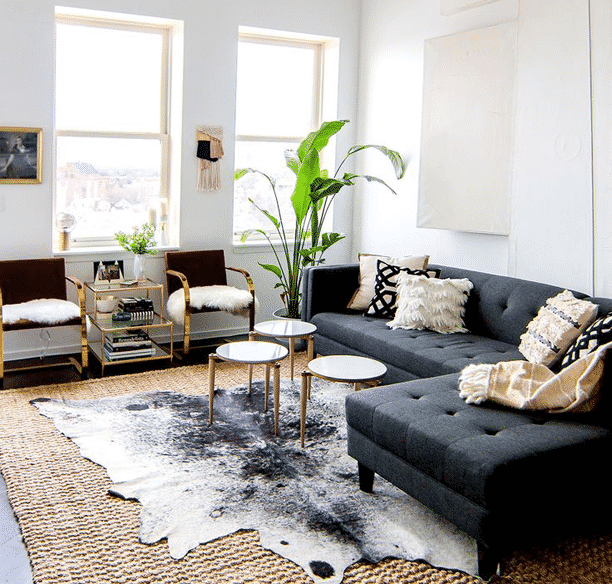 Beautifully layered modern modern rugs for any room in the home! LOVE this beautiful design trend and now you can incorporate it into your home with beautifully layered sisal, jute, cowhide, and modern rugs. Love this living room! 