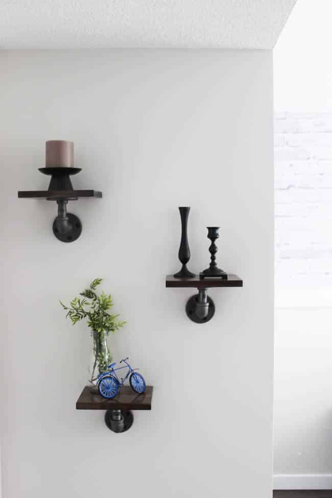 These mini industrial shelves are easy to build and perfect for any empty wall! These DIY pipe shelves are modern and beautiful!