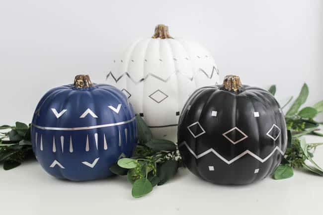Make your own modern fall decor! Use your Cricut Machine and adhesive foil to create these beautiful patterned pumpkins! LOVE the navy, black and white pumpkins for a non-traditional fall!