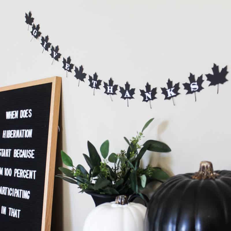 A beautiful modern fall decor idea. Make this simple black and white DIY leaf banner to celebrate Thanksgiving Day!