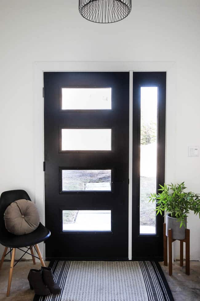 Thinking about replacing your front door? This is everything you need to know before you walk into The Home Depot and pick out a new design! We share how we got the proper measurements and picked our design elements before going to the store. Love the modern design of this new black front door!