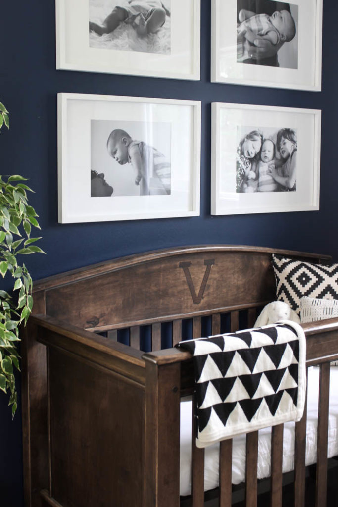 Beautiful ideas for a small modern nursery! This tiny baby room is off to the side of the master bedroom. Love the simple decor, from the navy wall to the brown crib and the beautiful gallery wall!