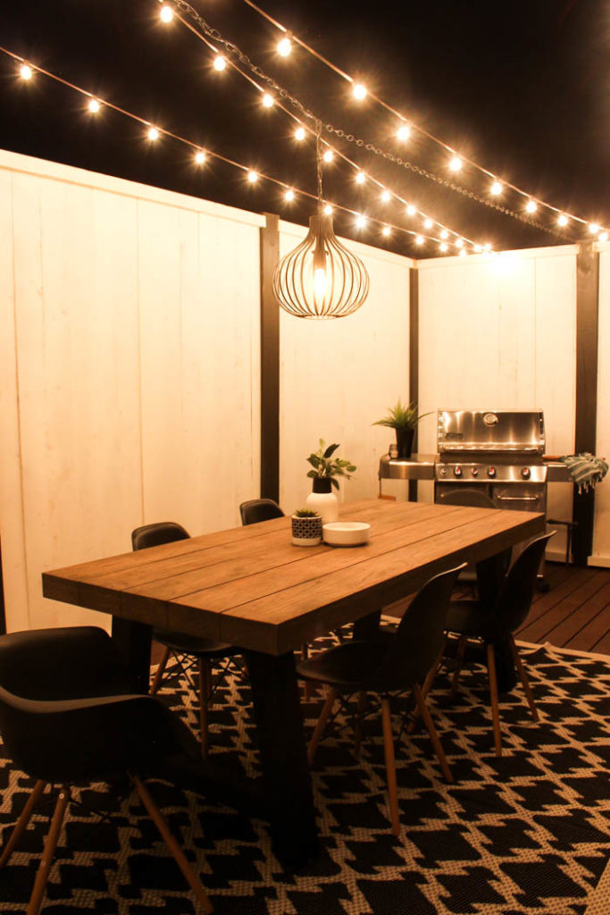 Wow! A beautiful modern outdoor space! The modern table from Article is a stunning addition to this outdoor deck. Finished off with a stunning black and white privacy wall and the gorgeous string lighting! 