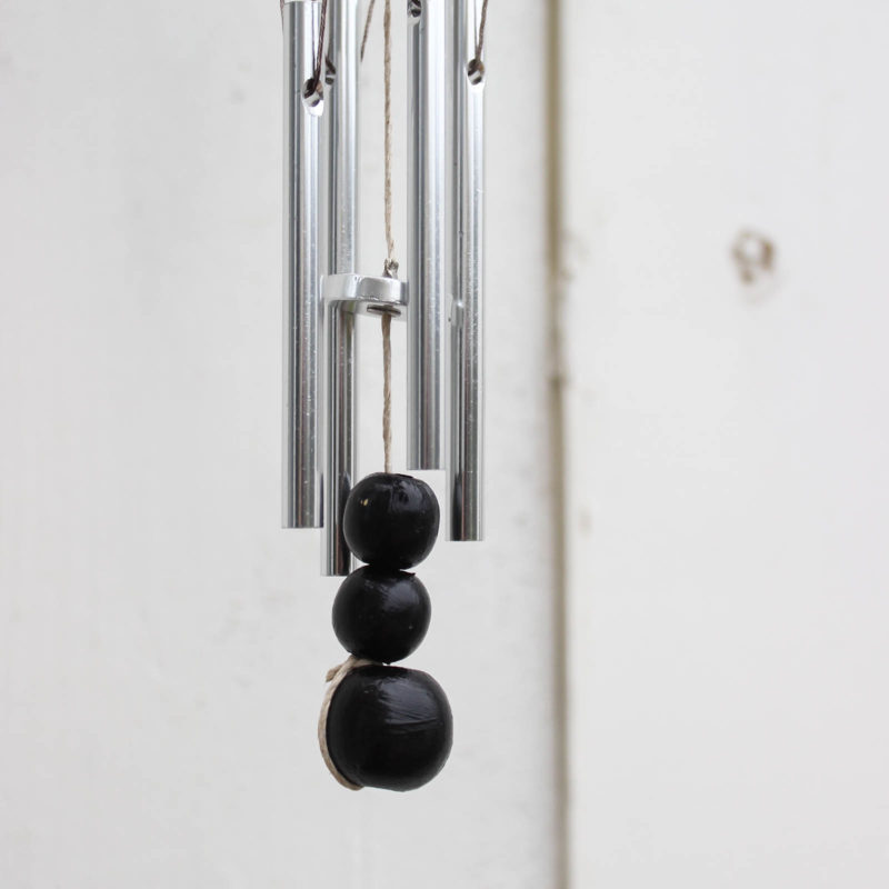 Beautiful modern wind chimes! Add beautiful decor to your outdoor space or deck with this simple thrift store update! Love the miniature houses and the stylish new take on wind chimes!