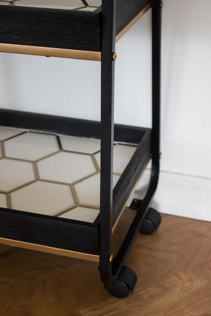 This modern bar cart is stunning! It's hard to believe that this is a DIY! Love the tile inlays and the mix of black, white, and gold in the design. Beautiful bar cart styling and ideas for your home entertaining! #DIY #barcart #tile #luxe #modern