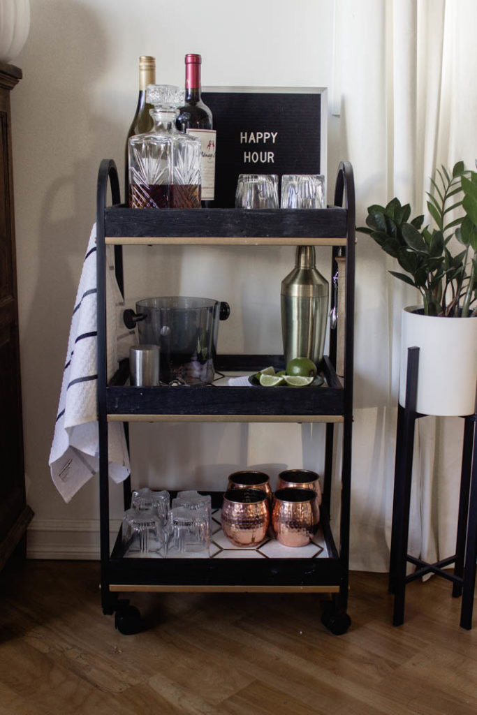 This modern bar cart is stunning! It's hard to believe that this is a DIY! Love the tile inlays and the mix of black, white, and gold in the design. Beautiful bar cart styling and ideas for your home entertaining! #DIY #barcart #tile #luxe #modern