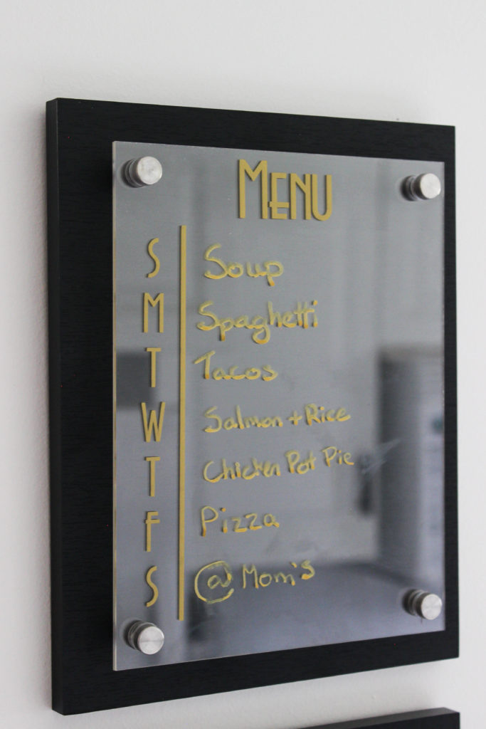 A simple, modern kitchen menu board. Love this meal planning idea! A simple way to create a weekly meal plan and grocery list. An easy vinyl project for Cricut beginners! #cricut #organization #mealplanning #kitchenorganization