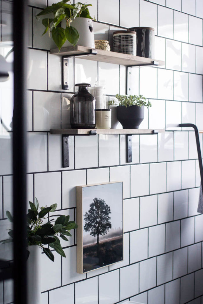 Love the look of this simple bathroom shelving! The open shelving is beautiful and so easy to build! Get tips and tricks for drilling into tile too! Love the modern bathroom design. #moderndesign #bathroom #DIY 