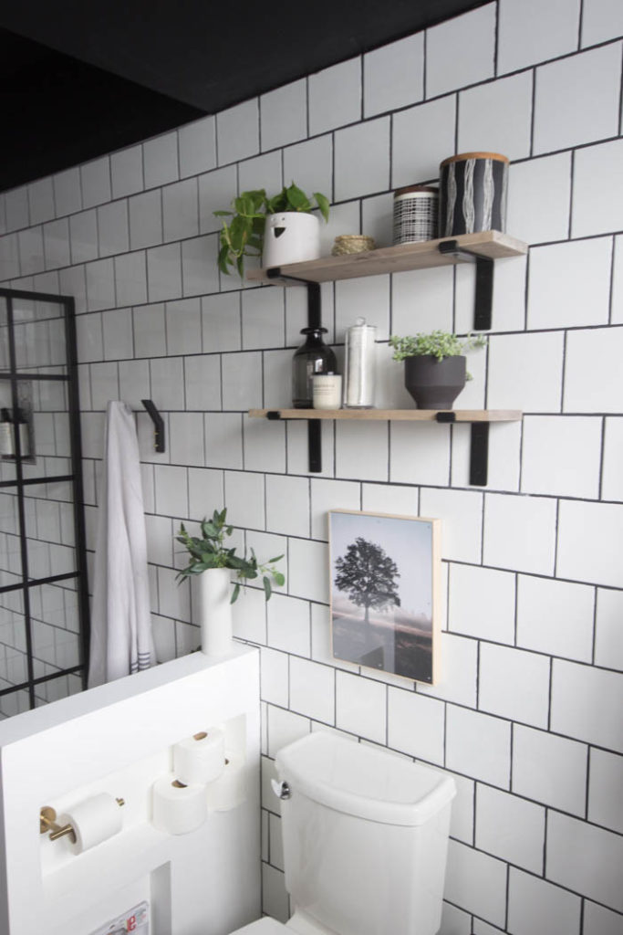 Love the look of this simple bathroom shelving! The open shelving is beautiful and so easy to build! Get tips and tricks for drilling into tile too! Love the modern bathroom design. #moderndesign #bathroom #DIY 