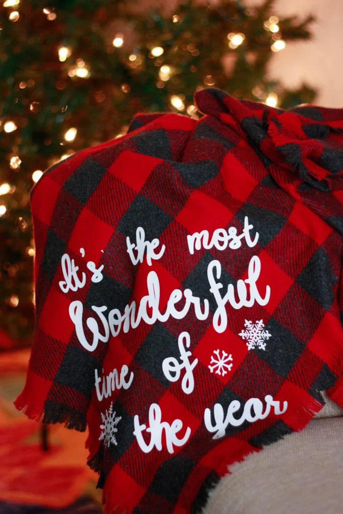 red flannel blanket with "its the most wonderful time of the year" text