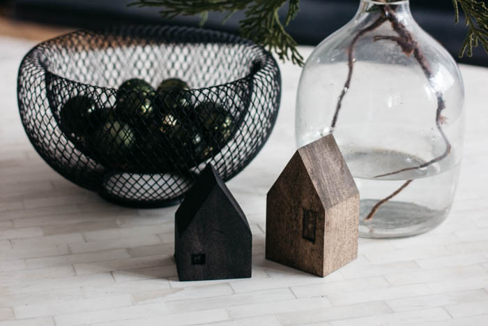 These DIY Mini Wooden Houses are adorable! Love the simple & modern design. The dark stains are beautiful. It's the perfect addition to any coffee table or shelf styling! A great scrap wood project! #scrapwood #winterdecor #holiday #minihouse #woodworking
