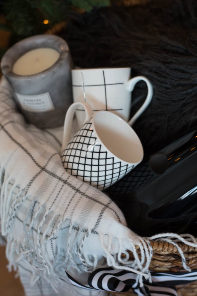 A great gift basket idea for the holiday homebody. Give them the gift of a night in with coffee, and cozy home decor! It would also be a great gift idea for couples! #Christmas #gifts #homebody