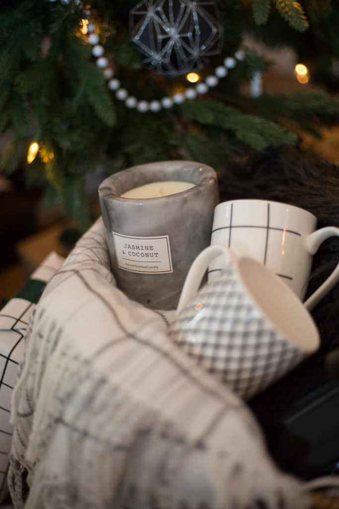 A great gift basket idea for the holiday homebody. Give them the gift of a night in with coffee, and cozy home decor! It would also be a great gift idea for couples! #Christmas #gifts #homebody