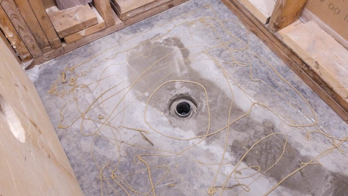 How to install a shower pan and drain. A great video tutorial and step-by-step guide to installing a shower pan or base and drain. Also shares how to install the waterproofing system using the Ubau Flo kit. #renovations #renobloggers