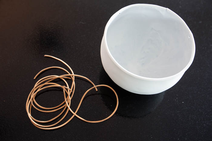 leather string for a white flower pot