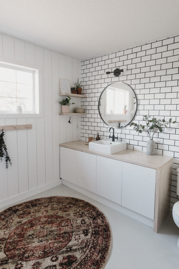 Tiled wall with subway tile in bathroom