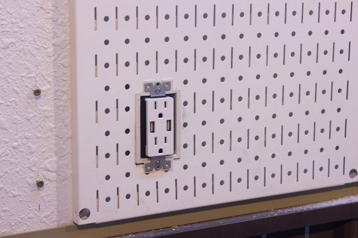 outlet installed in metal pegboard