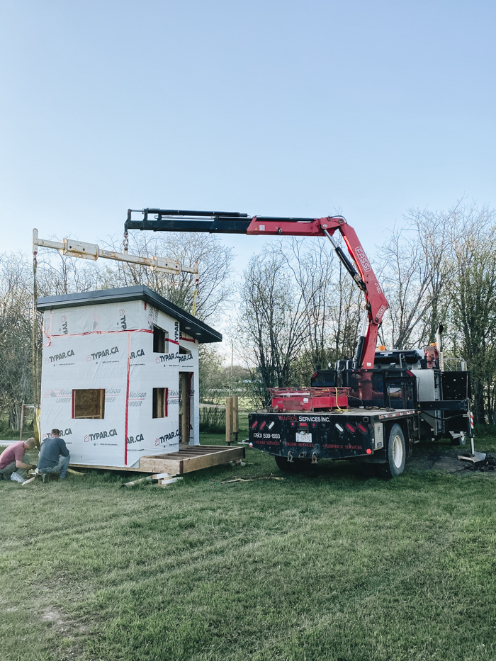 raising the playhouse with a picker truck