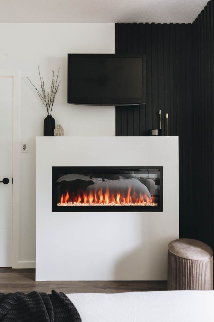white fireplace surround with black wall
