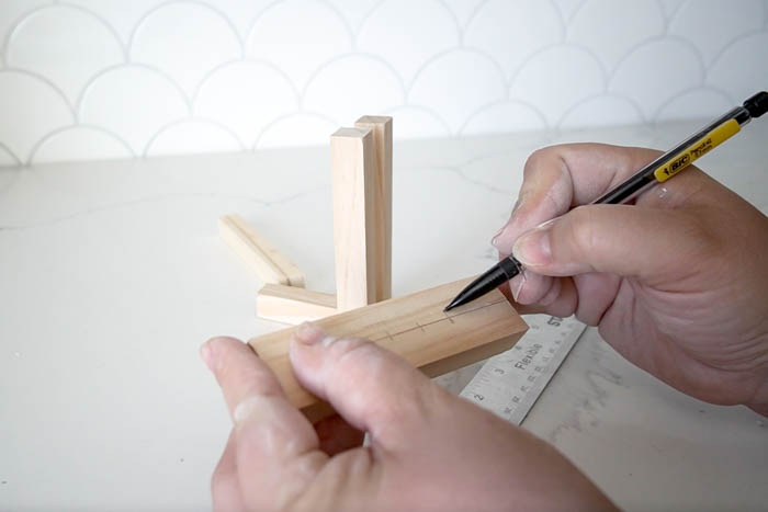 marking cut dowels with a pencil for glueing