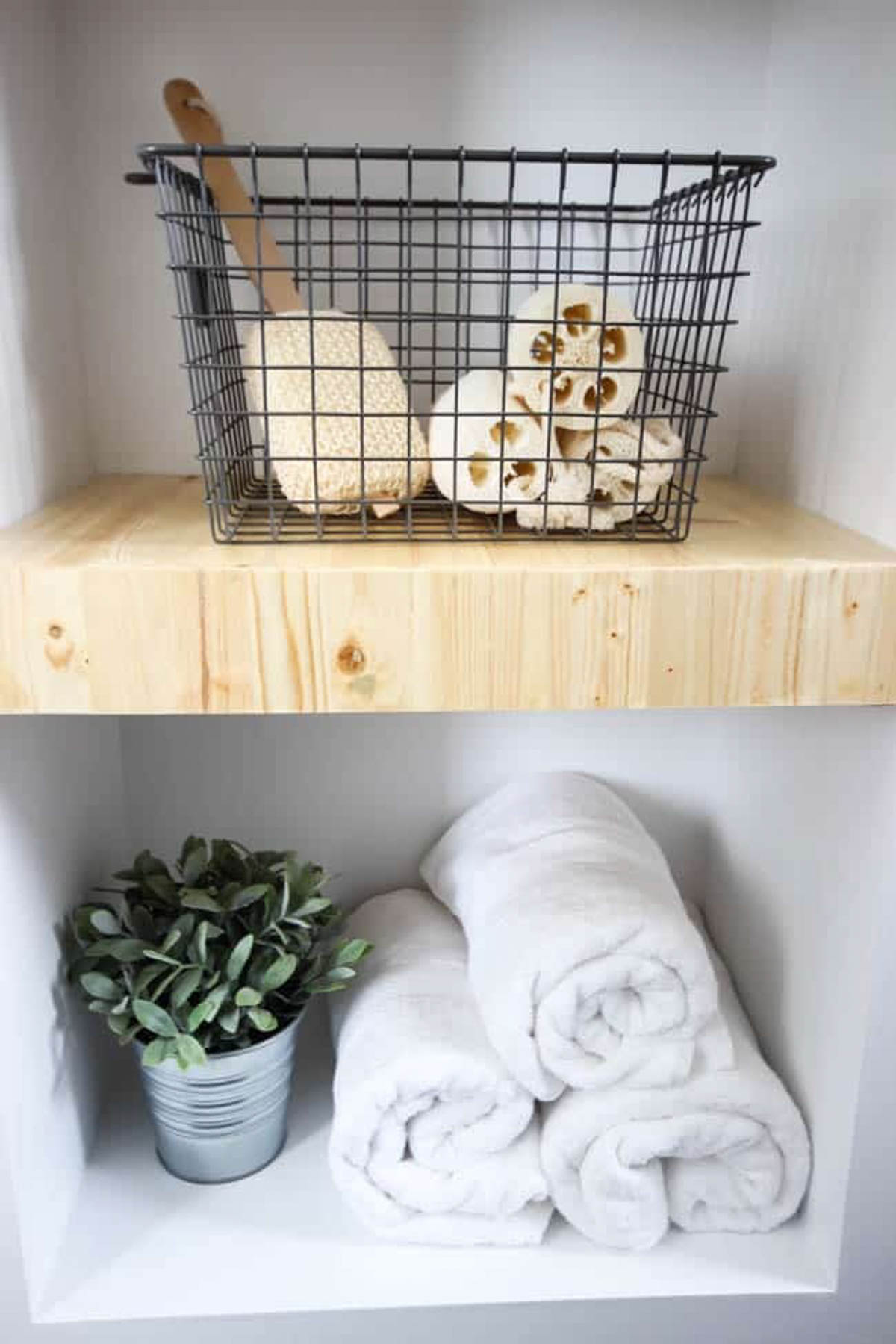 Decorated DIY built-in shelving in a bathroom