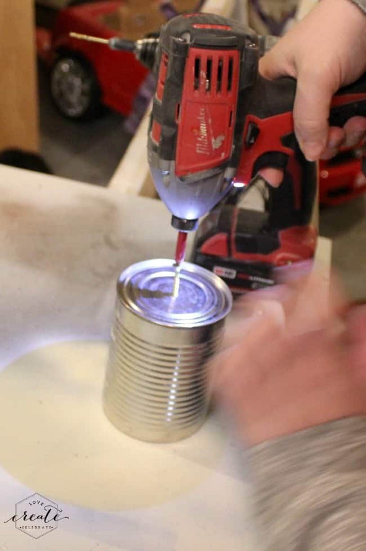 Using a drill and screw to drill into tin can