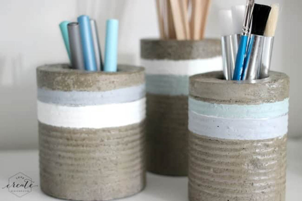 Three concrete vases made using tin cans