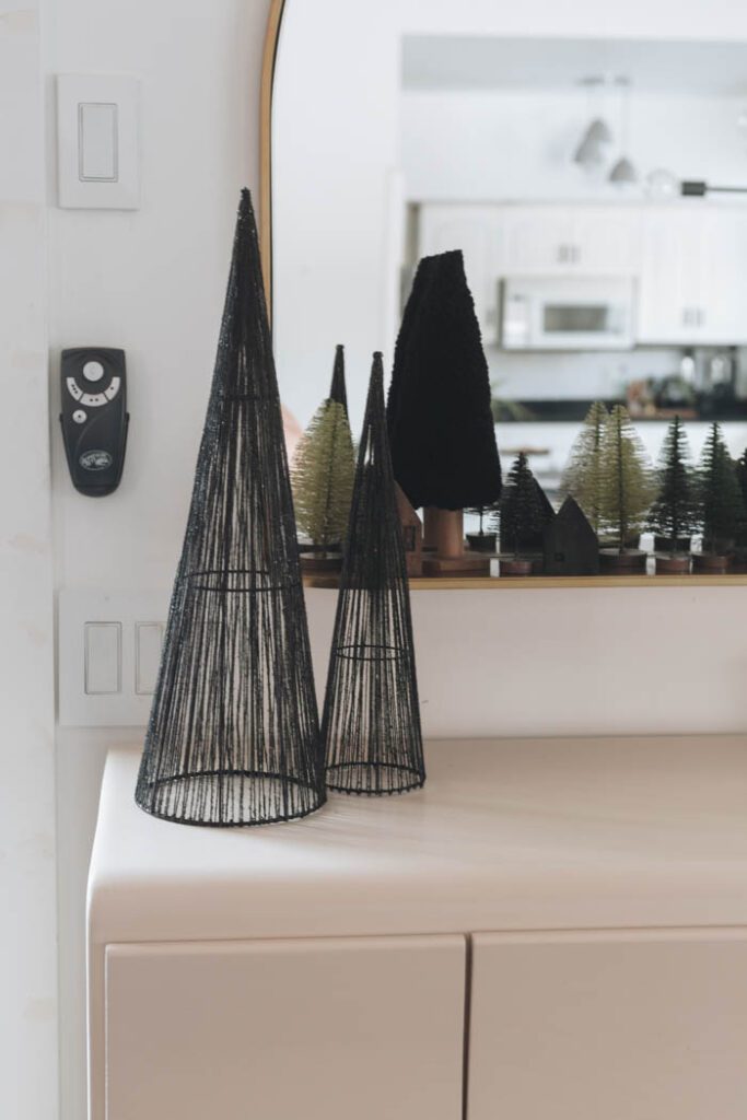Modern decorating with a mirror and bottle brush trees