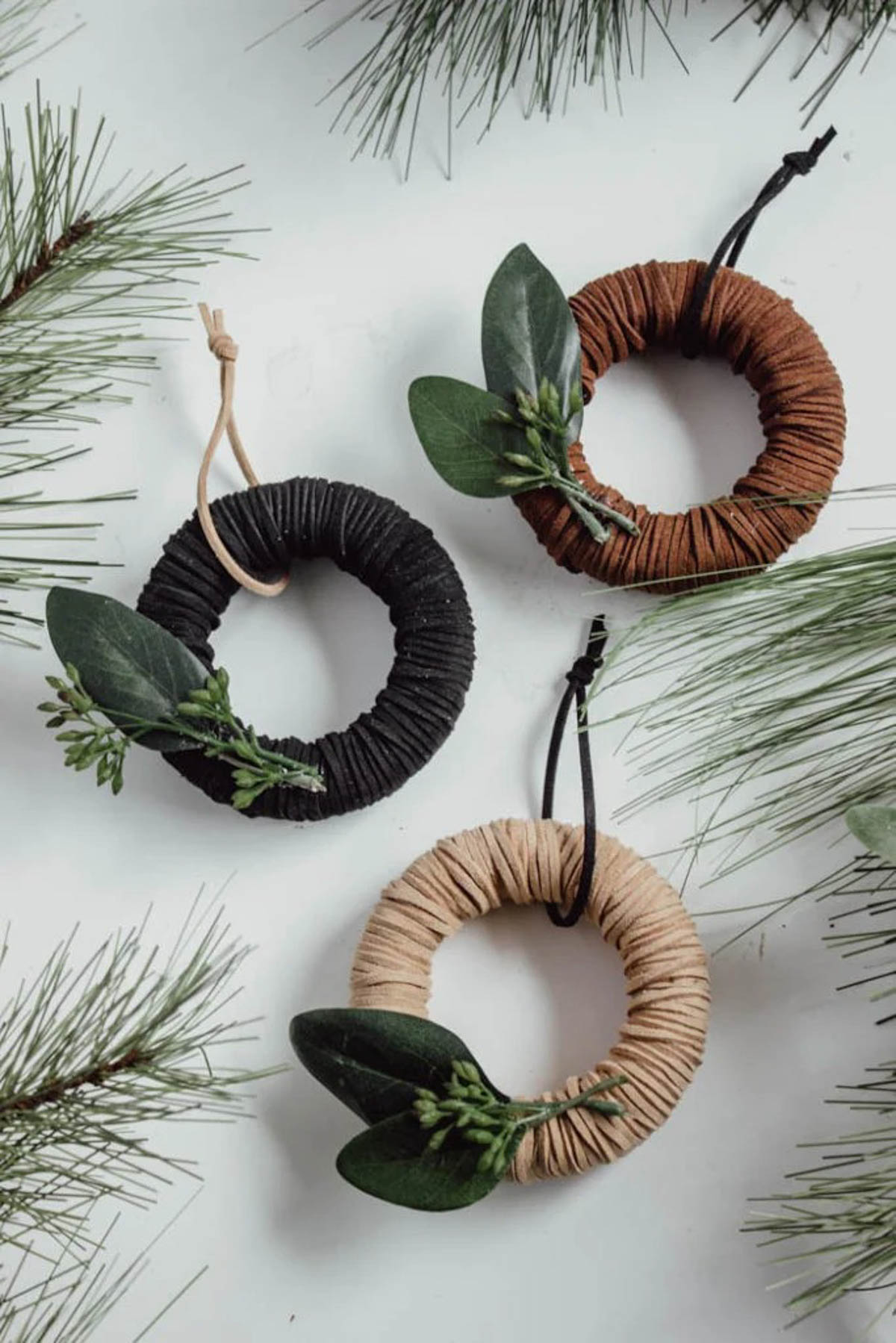 Set of three mini wreath ornaments made with leather.