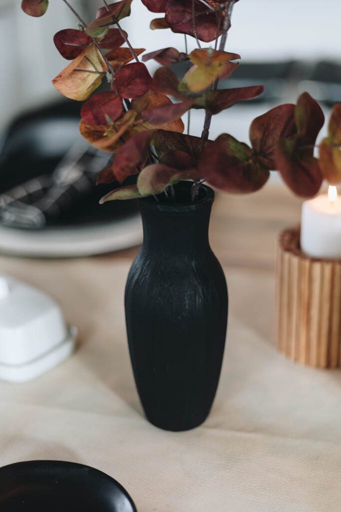 black vase with fall stems