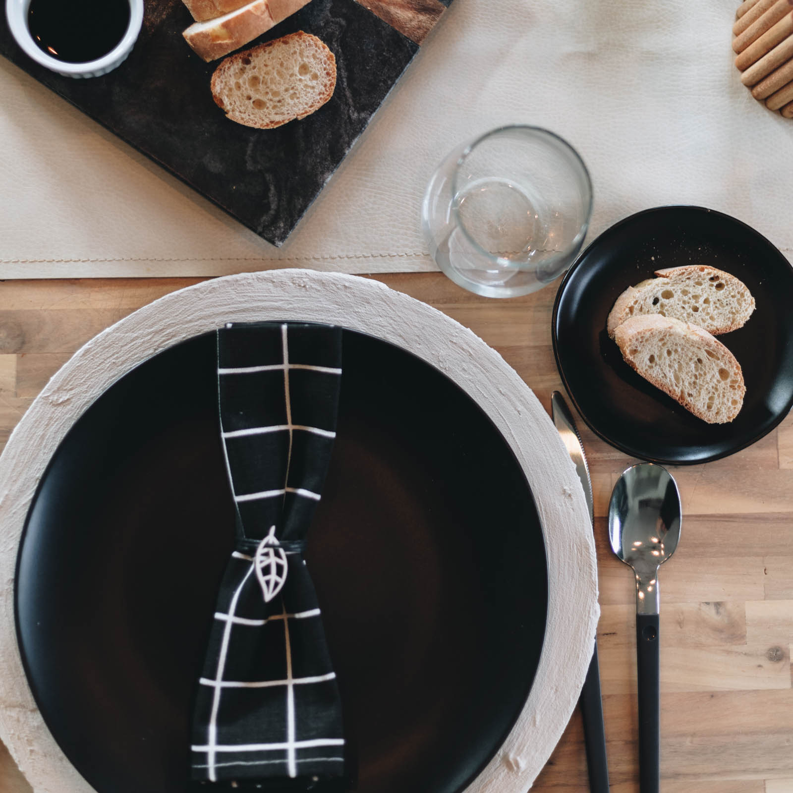 baking soda and paint chargers in place setting with black paint and black and white napkin