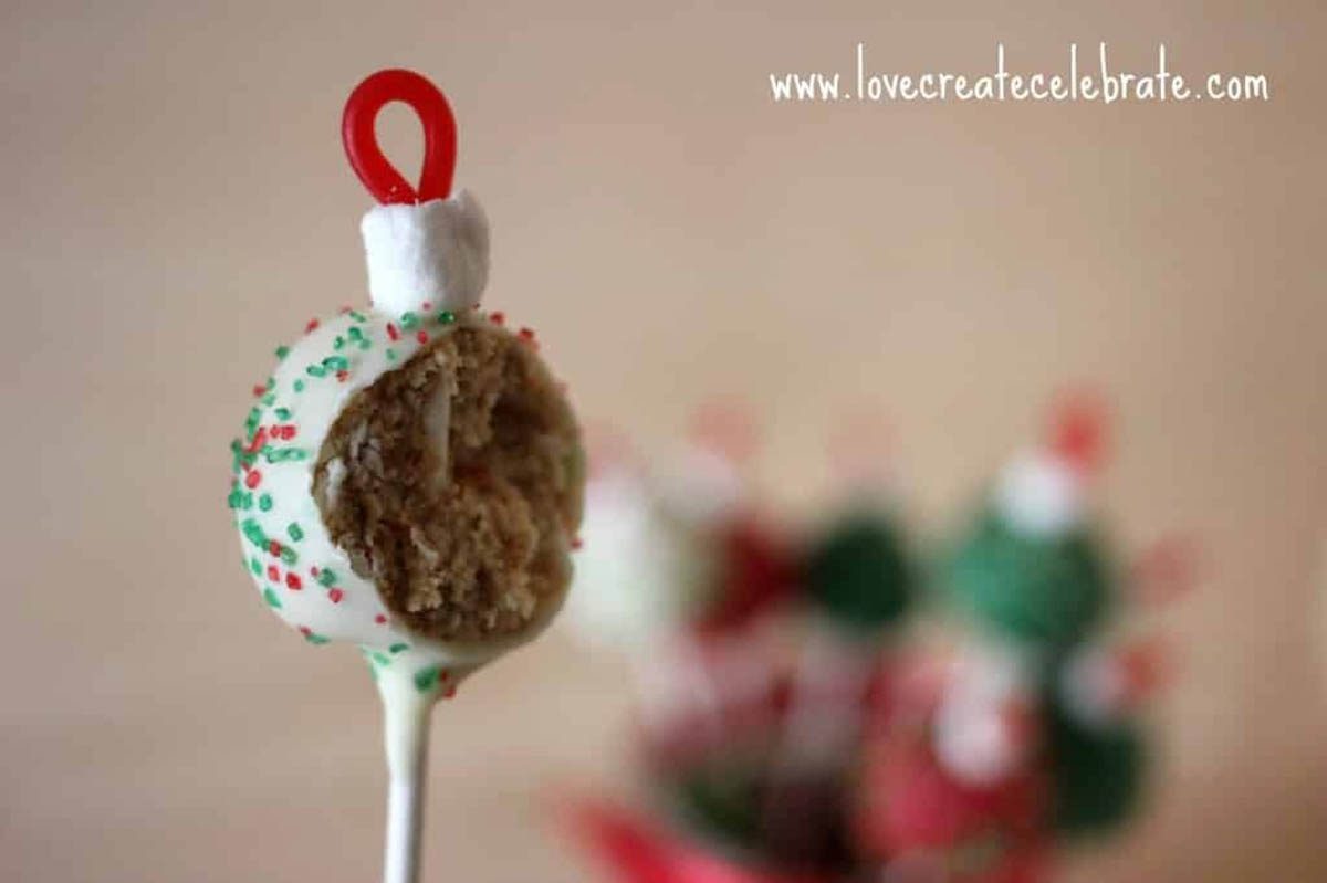 White ornament cake pop with a bite taken out of it.