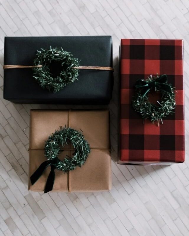 three gifts with mini Christmas wreaths