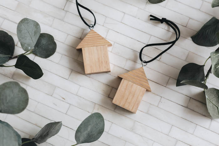 flat lay image of two wooden house ornaments