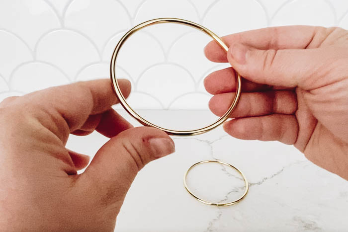 hands holding a brass ring