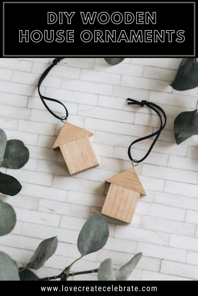 flat lay image of two wooden house ornaments