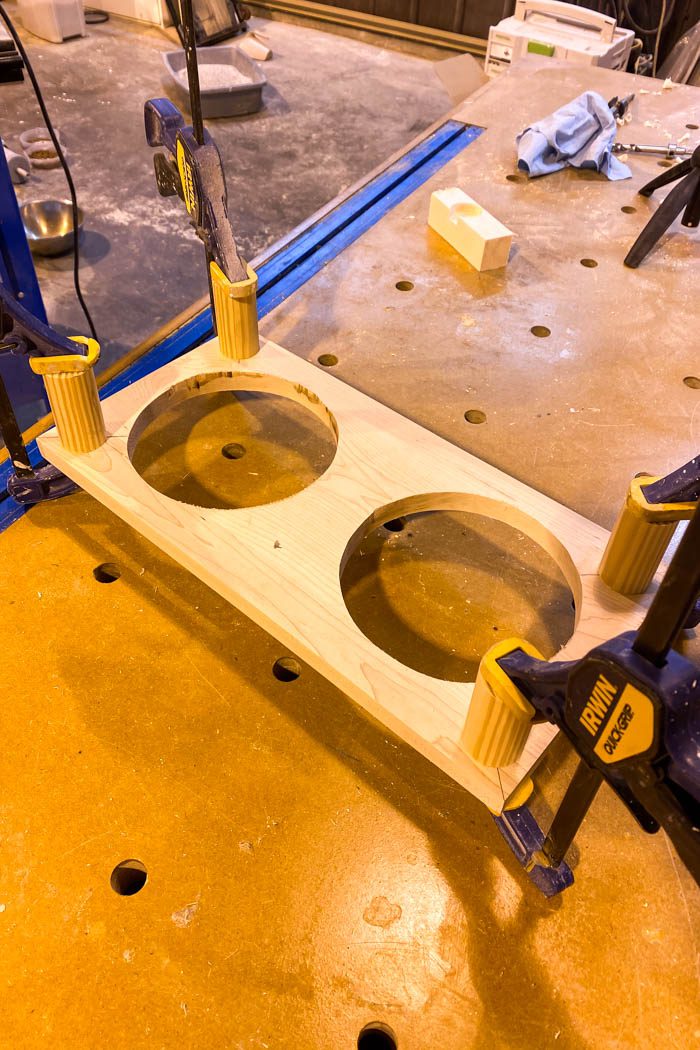 legs of DIY dog bowl stand attached using wood glue and clamps