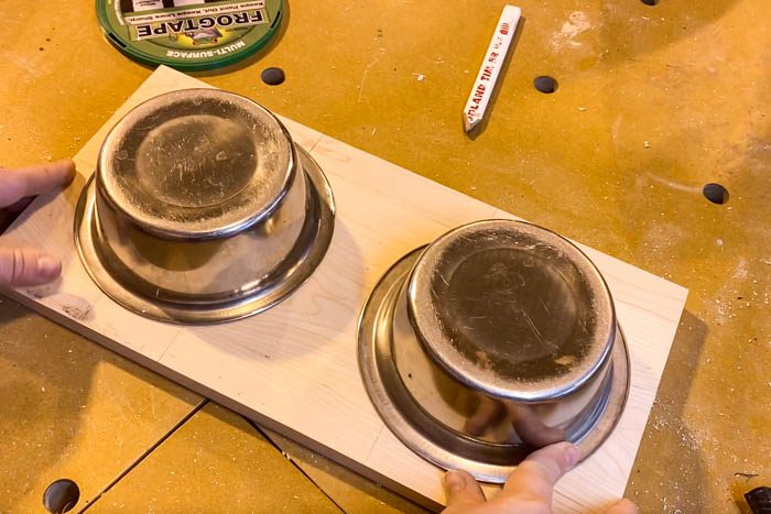 stainless steel dog bowls sitting on board