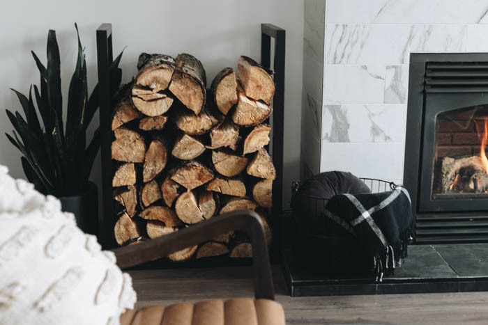 DIY fire wood rack next to fireplace with wood